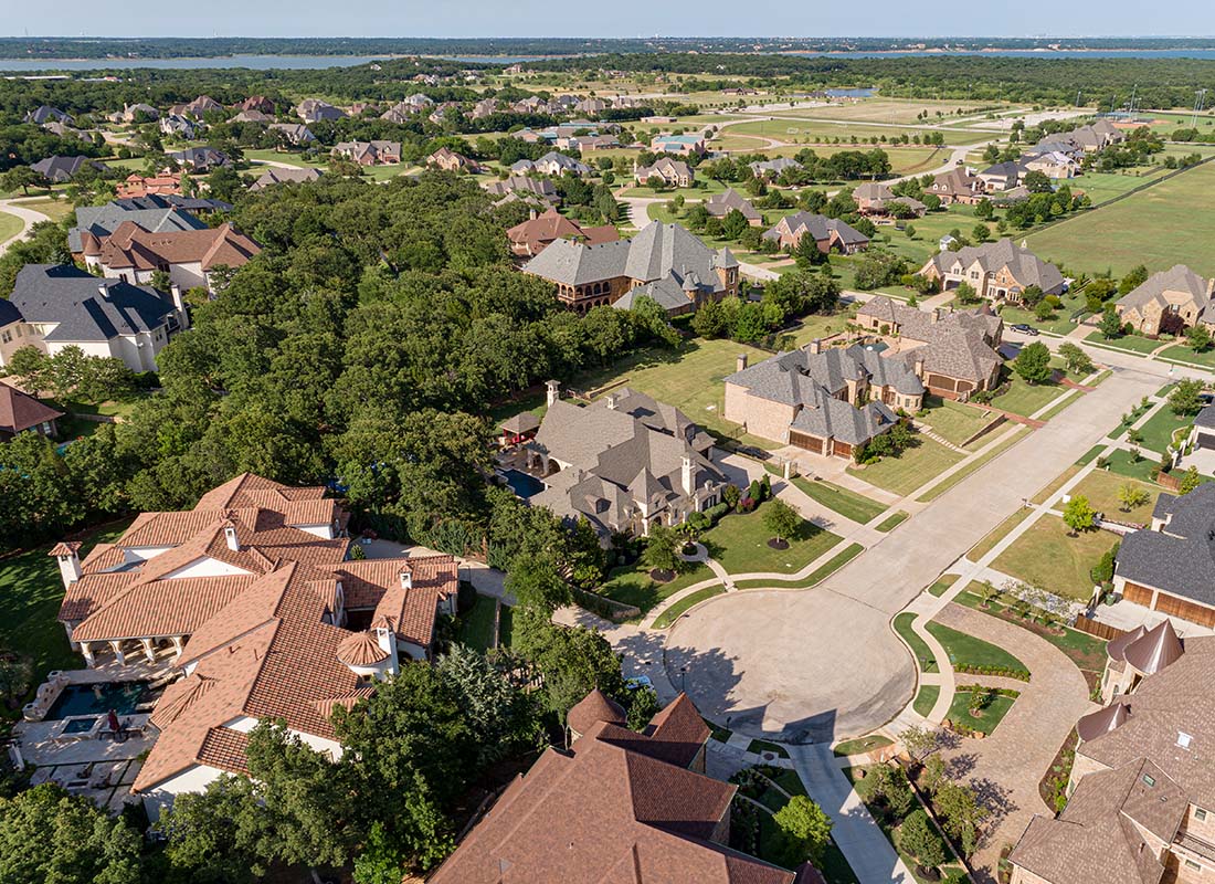 Southlake, TX - Aerial View of Luxury Multi Story Homes and Estates in a Quiet Neighborhood with Green Grass and Trees in Southlake Texas