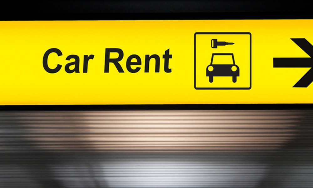 Blog - Close Up of Car Rent Sign in an Airport
